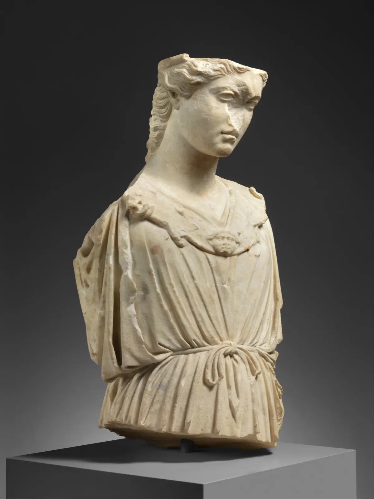Marble bust, sunlit against the painted sky