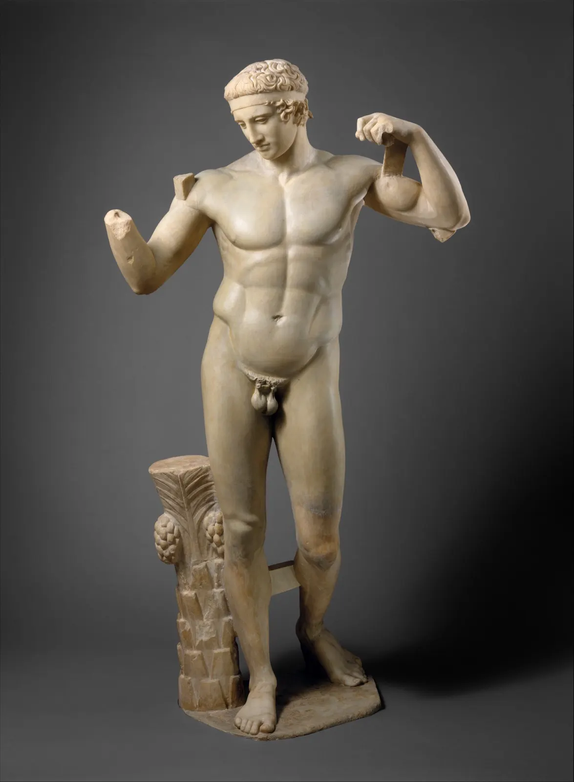 Marble statue of a youth tying a victory ribbon